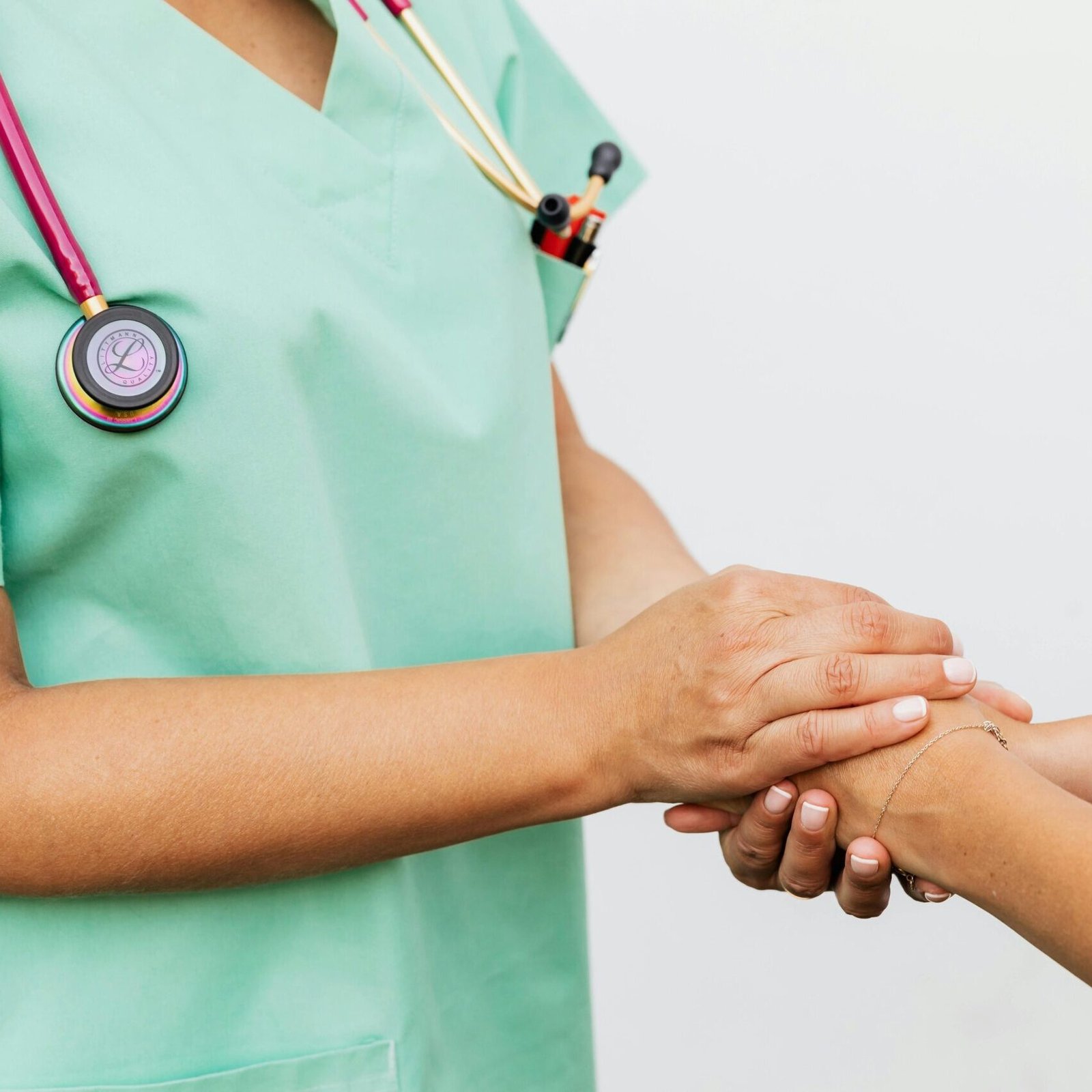Close-up of a doctor holding a patient's hands, symbolizing trust and empathy in healthcare.